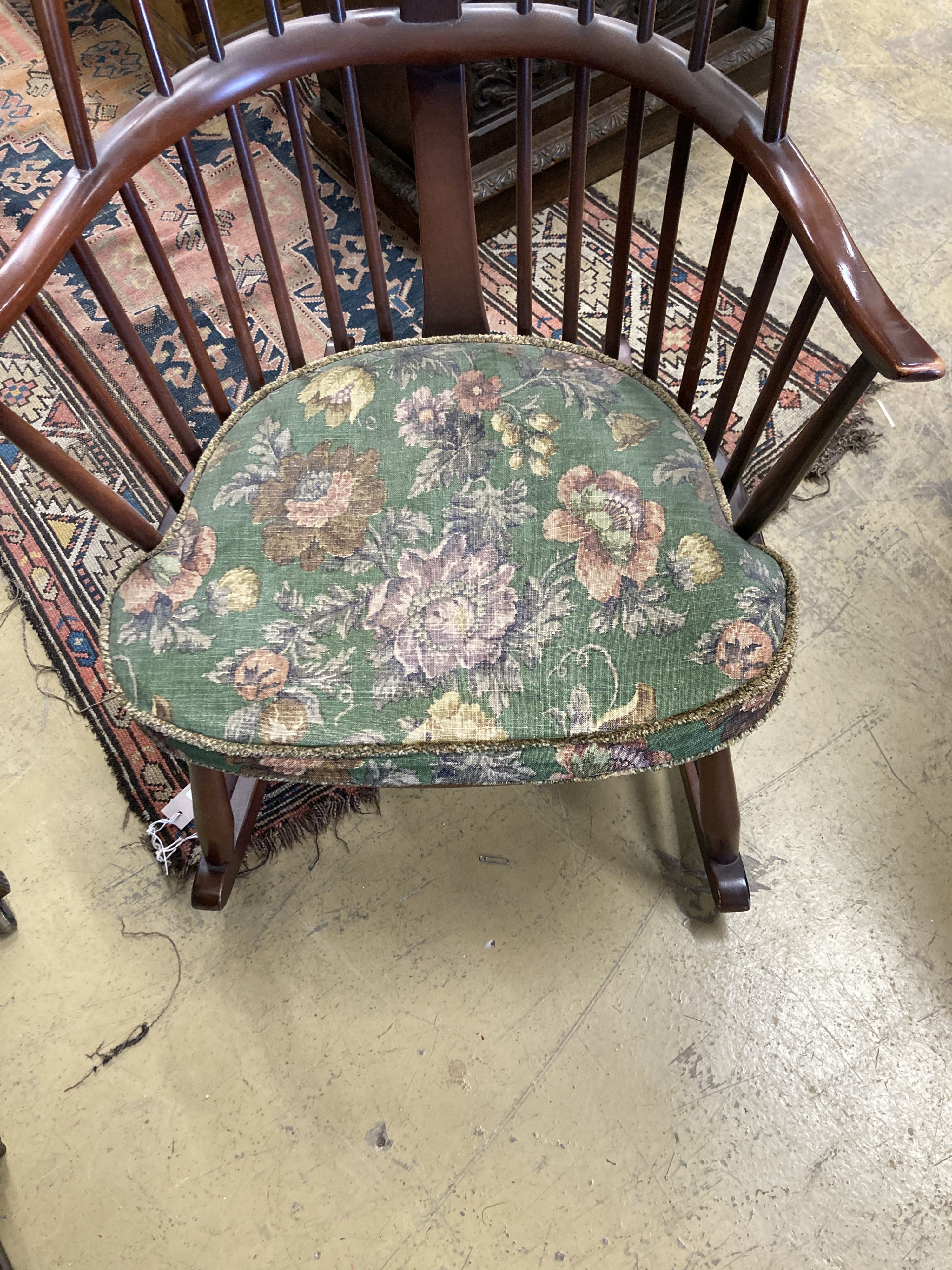 An Ercol comb back stained beech rocking chair, width 60cm, depth 50cm, height 106cm